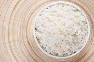 Image showing Rice in a bowl on a bamboo plate