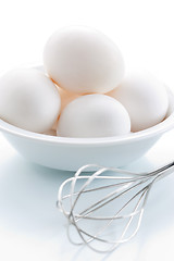Image showing Whisk and fresh eggs