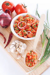 Image showing Salsa in a bowl on a wooden board and ingredients
