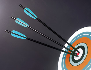 Image showing Three Blue Black Archery Arrows Hit Round Target Bullseye Center