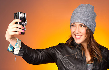 Image showing Hip Woman Snaps a Self Portrait with Vintage Camera