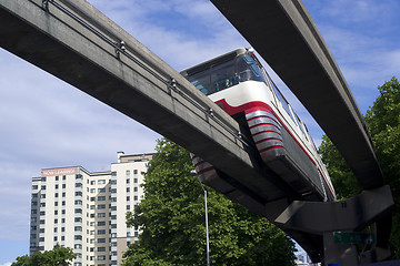Image showing Monorail Transit Train Travels Over Neighborhood Carrying People