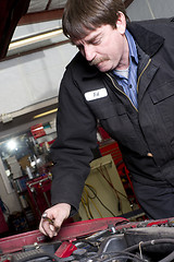 Image showing Automotive Technician Works Under the Car Hood in Auto Repair