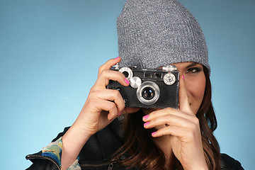 Image showing Hip Woman Snaps a Picture of Viewer with Vintage Camera