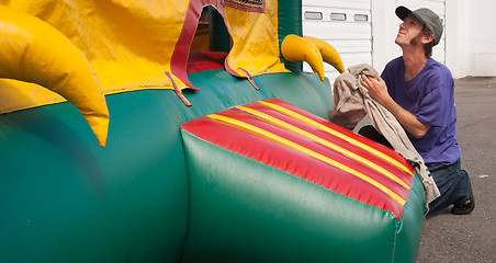 Image showing Man Cleans Party Place Equipment Rental Fun Bouncy Balloon