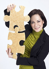 Image showing Woman Working With Two Large Jigsaw Puzzle Pieces