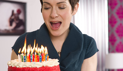 Image showing Attractive Female Readies to Blow Out Birthday Cake Candles