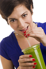 Image showing Woman sips Green Smoothie