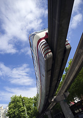 Image showing Monorail Transit Train Travels Over Neighborhood Carrying People