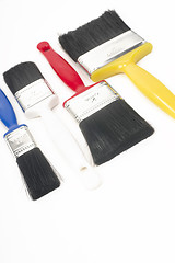 Image showing Colorful Tools for Creating Paint Brushes Lay Together on White