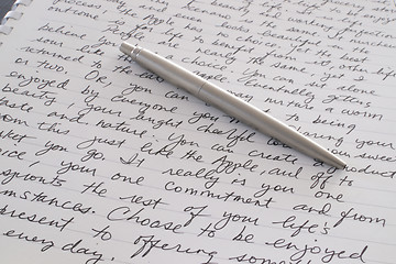 Image showing Stainless Steel Pen Laying on Written Page