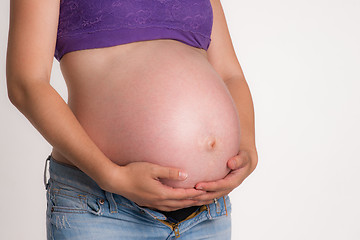 Image showing Pregnant Woman Expecting Baby Torso Standing Hands on Belly