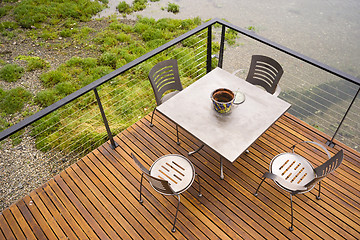 Image showing Wood Plank Deck Patio Beach Water Stainless Steel Dining Set