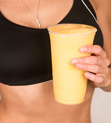 Image showing Slender Female Torso Tanned Toned Body Blended Fruit Smoothie Dr