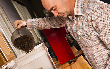 Image showing Production House Owner Weighing Roasted Coffee For Packaging Dis