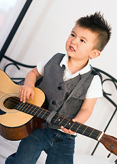 Image showing Young Boy Jamming Full Size Guitar Gritting Teeth Playing Musici