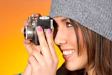 Image showing Hip Woman Snaps a Picture with Vintage Camera