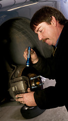 Image showing Auto Technician Mechanic Checks Rotors on Car Braking System