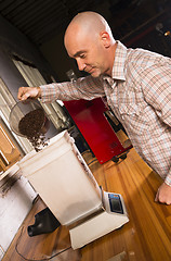 Image showing Production House Owner Weighing Roasted Coffee For Packaging Dis