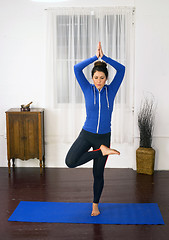 Image showing Young Attractive Woman Stands Tree Pose Blue Mat Yoga Dance Stud