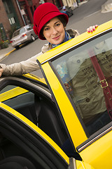 Image showing Woman Smiling Wearing Bright Accents Enters Taxi Cab Automobile 