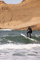 Image showing Man Black Wetsuit Ocean Surf Riding Paddle Board Summer Sport