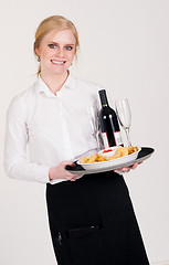 Image showing Pretty Waitress Brings Appetizers and Wine Food Restaurant