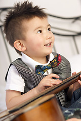 Image showing Happy Two Year Old Boy Interested in Arts and Music