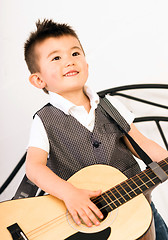 Image showing Young Boy Jamming Full Size Guitar Gritting Teeth Playing Musici