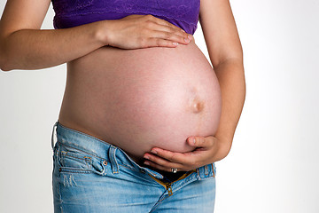 Image showing Pregnant Woman Expecting Baby Torso Standing Hands on Belly