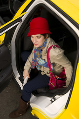 Image showing Woman Wearing Bright Accents Steps Out Taxi Cab Automobile Downt