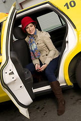 Image showing Woman exits a Taxi