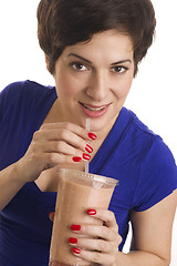 Image showing Woman sips Flesh Tone Smoothie