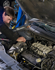 Image showing Automotive Technician Works Under the Car Hood in Auto Repair