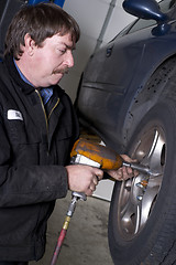 Image showing Automotive Technician Uses Pneumatic Impact Wrench Auto Repair B