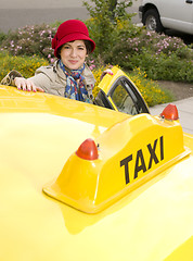 Image showing Woman enters a Taxi