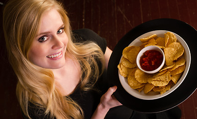 Image showing Young Attractive Female Server Brings Appetizer Chips Salsa Food