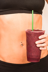 Image showing Slender Female Torso Tanned Toned Body Blended Fruit Smoothie Dr