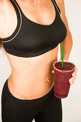 Image showing Slender Female Torso Tanned Toned Body Blended Fruit Smoothie Dr