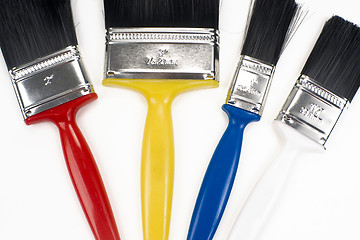 Image showing Colorful Tools for Creating Paint Brushes Lay Together on White