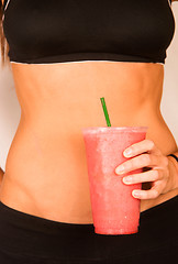 Image showing Slender Female Torso Tanned Toned Body Blended Fruit Smoothie Dr