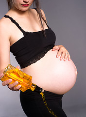 Image showing Pregnant Woman Alcoholic Expecting Baby Pours Alcohol Empties Wh