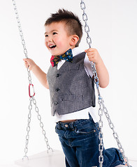 Image showing Happy Young Boy Plays Swing Suspended Moving Laughing Child Play