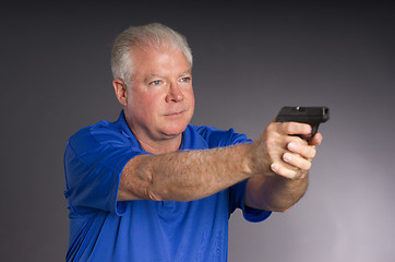 Image showing Man Defends Himself Holding Pointing Small Semi Sutomatic Handgu