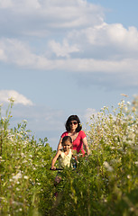Image showing Mother and daughter cycling
