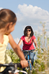 Image showing Mother and daughter cycling