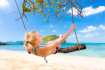 Image showing Lady swinging on the tropical beach