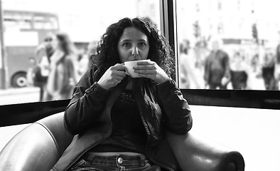 Image showing Pretty brunette drinking coffee tea