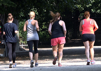 Image showing Four women running outdoors