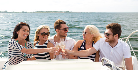 Image showing smiling friends with glasses of champagne on yacht